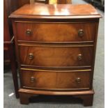 A mahogany bow front chest of three drawers.