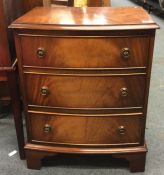 A mahogany bow front chest of three drawers.