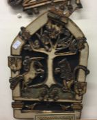 A large unusual pottery wall plaque depicting a ra