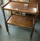 An oak barley twist tea trolley.