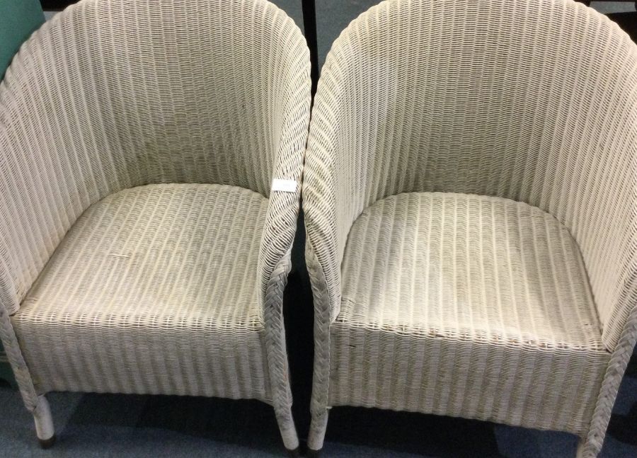 Two Lloyd Loom type chairs.