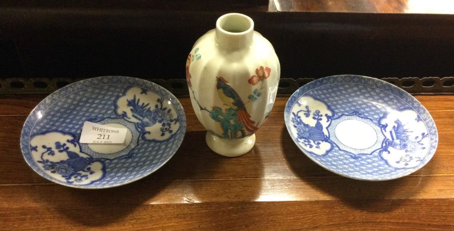 Two Chinese blue and white plates together with a