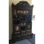A large Chinese carved cabinet attractively decora