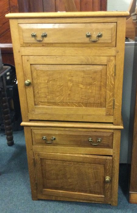 A pair of oak bedside cabinets.