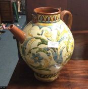 A large pottery jug decorated with stylised flower