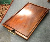 A mahogany hinge top butlers table.