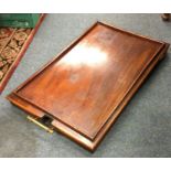 A mahogany hinge top butlers table.