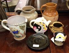 CLARICE CLIFF: A teapot and cup together other pot