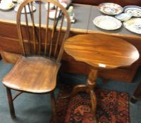 An Antique stick back chair together with a table.