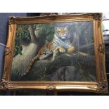 An oversized gilt framed oil on canvas of a tiger