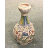 A baluster shaped vase decorated in bright colours.