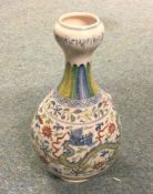 A baluster shaped vase decorated in bright colours.