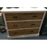 A stripped pine chest of three drawers.