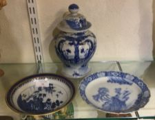 Two Chinese plates together with a vase.