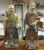 A good matched pair of Chinese figures decorated i