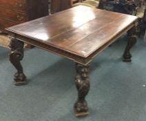 A good oak dining table on four carved legs.