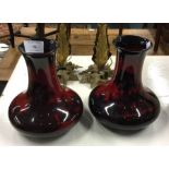 A pair of Royal Doulton vases in red ground.