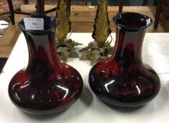A pair of Royal Doulton vases in red ground.