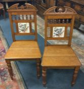 A pair of oak hall chairs.