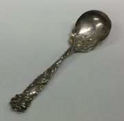 A large chased silver caddy spoon together with a