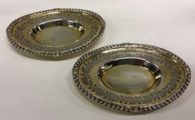 A fine pair of George III silver gilt dishes engra