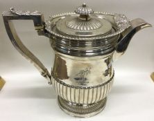 A large and fine silver water jug with shell borde