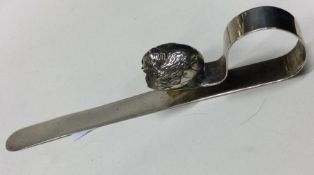 CHESTER: A silver letter opener decorated with a c