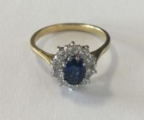 A good diamond and sapphire oval cluster ring, the