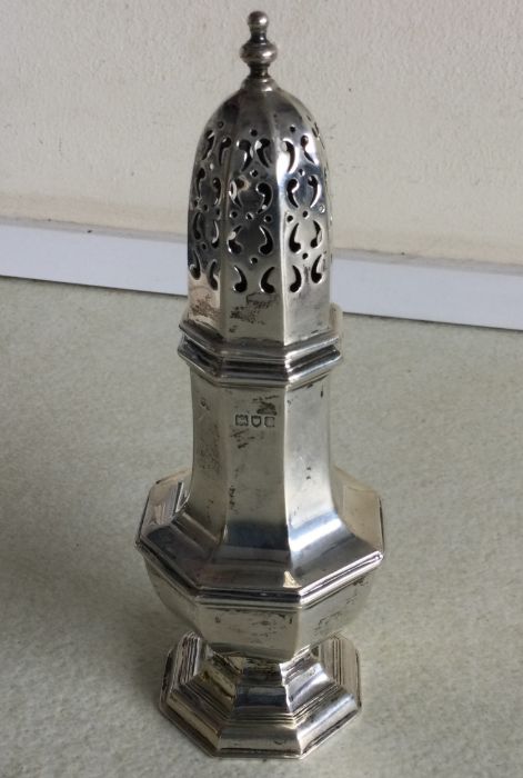 A heavy silver caster with lift-off cover. London.