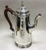 A heavy Georgian style silver coffee pot with stra