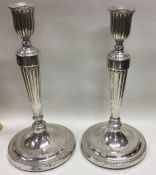 A fine and heavy pair of George III silver candles