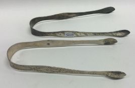 Two pairs of Georgian silver bright cut sugar tong