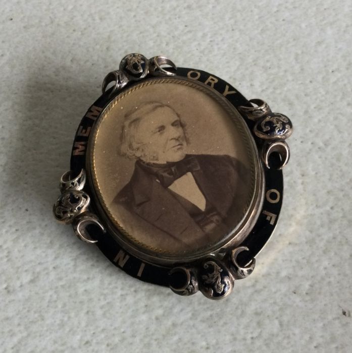 A large gold plated and enamelled mourning brooch