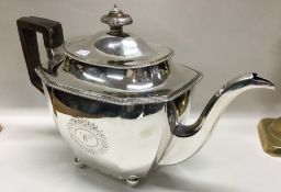 A heavy George III silver teapot on ball feet. Lon