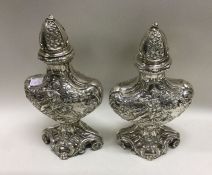 A fine pair of chased silver casters. London late