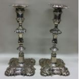 A heavy pair of George II cast candlesticks with c