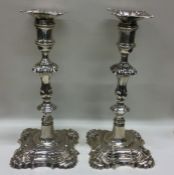 A heavy pair of George II cast candlesticks with c