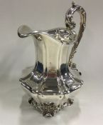 A good Victorian silver cream jug on four scroll f