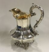 A good Victorian silver cream jug on cast scroll f