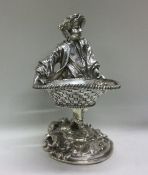 A rare and heavy silver figure of a man holding a