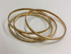 A heavy set of four 21 carat gold slave bangles. A