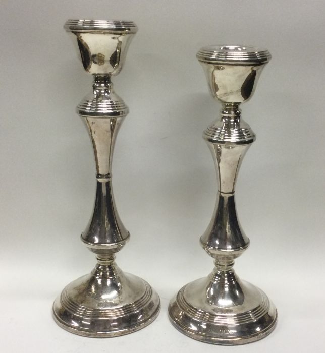 A tapering pair of large silver candlesticks with
