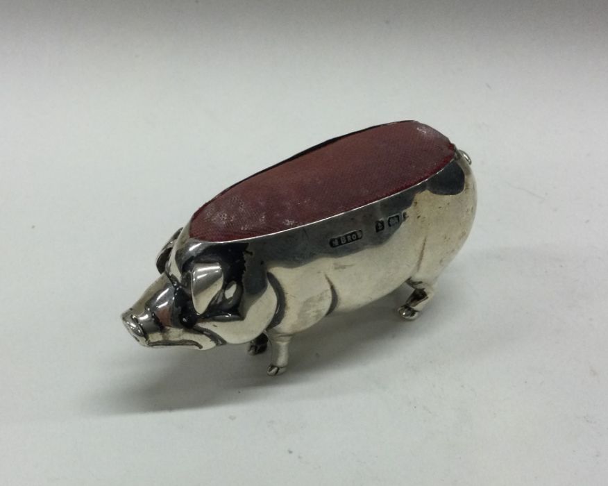 A silver pin cushion in the form of a pig. Birming