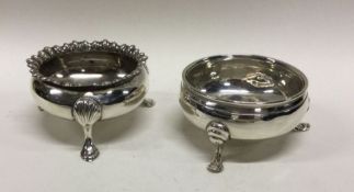 Two circular silver salts on cabriole legs. Approx