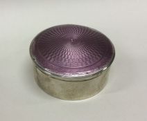 A heavy silver and enamel circular box with lift-o