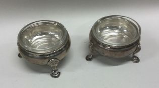 A George III pair of circular silver salts with gl