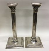 A heavy pair of cast silver candlesticks of Corint