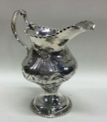 A large Georgian silver cream jug with swag decora