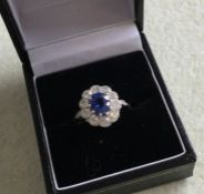 A fine quality oval sapphire and diamond cluster r