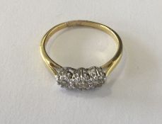 A diamond three stone ring in 18 carat and platinu